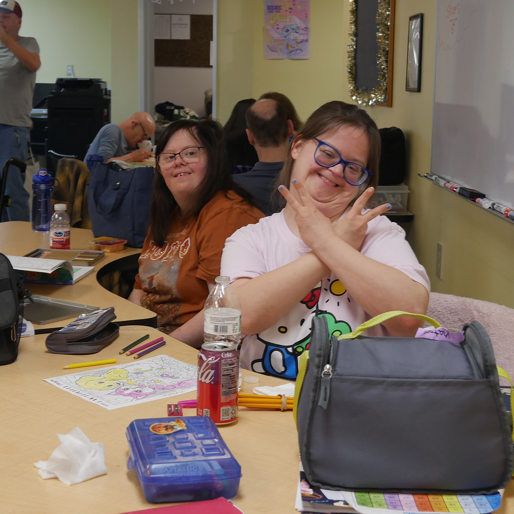 A person coloring and posing and smiling for the picture