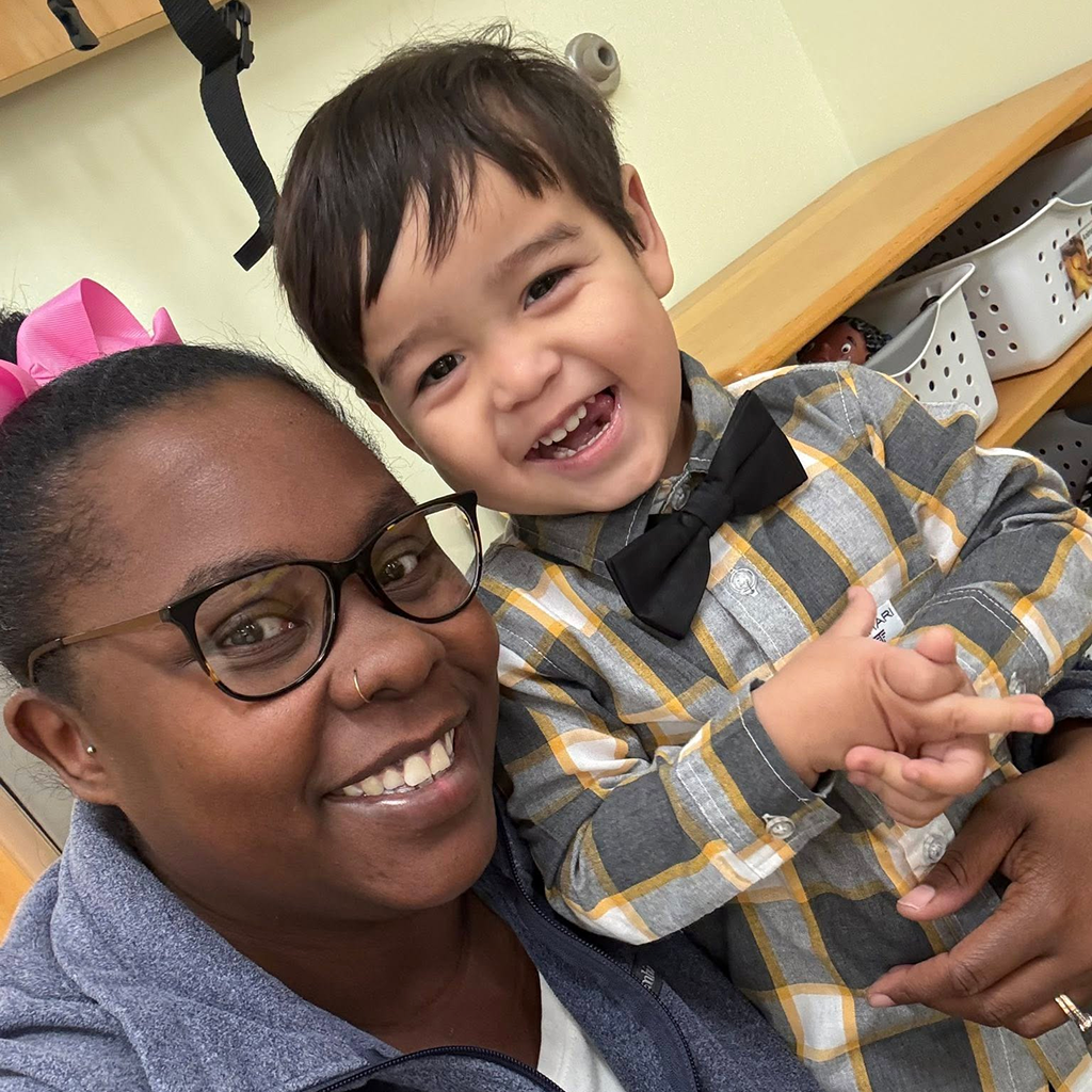 A mom smiling with her kid