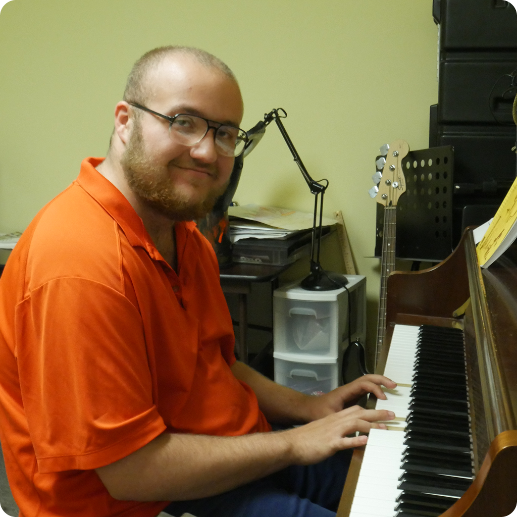 A person coloring and posing and smiling for the picture